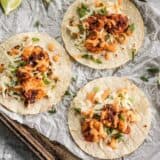 Smoky and spicy shrimp, sweet and tangy slaw, and a zesty garlic lime sauce make these Blackened Shrimp Tacos seriously delicious! BudgetBytes.com