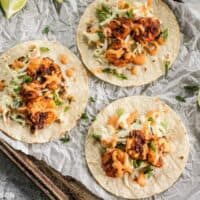 Smoky and spicy shrimp, sweet and tangy slaw, and a zesty garlic lime sauce make these Blackened Shrimp Tacos seriously delicious! BudgetBytes.com