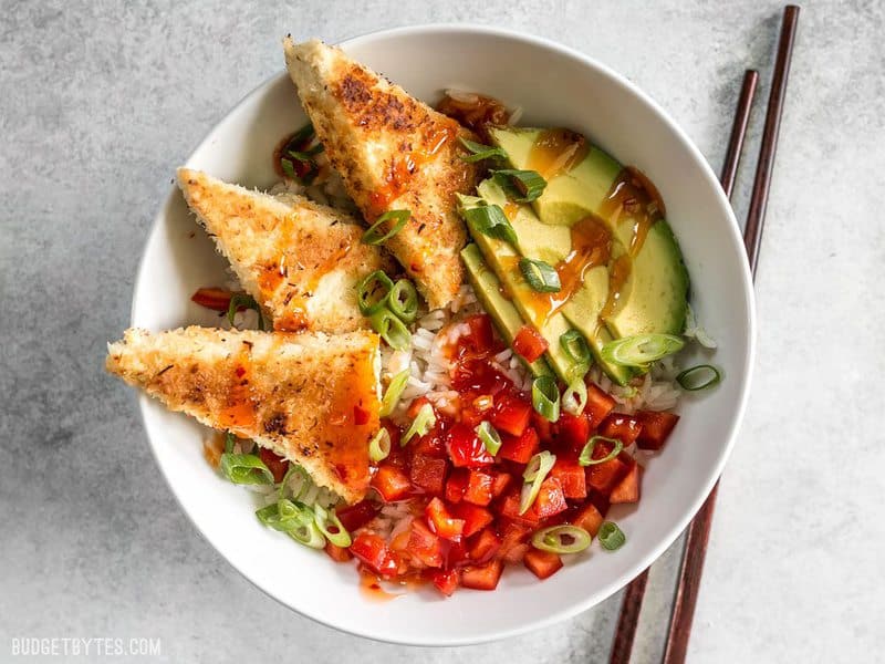 Coconut Crusted Tofu made into a bowl meal with rice, red bell peppers, and avocado.