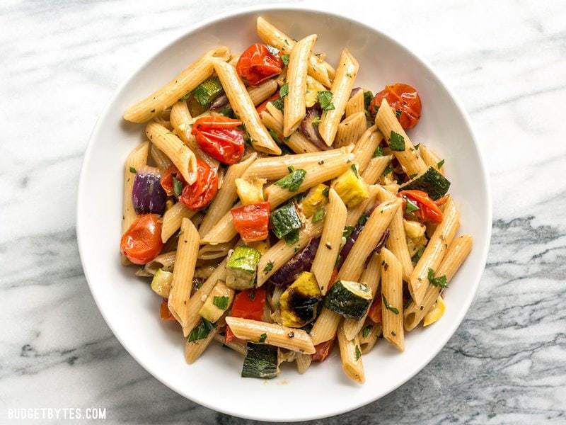 A big bowl of Grilled Vegetable Pasta Salad garnished with parsley