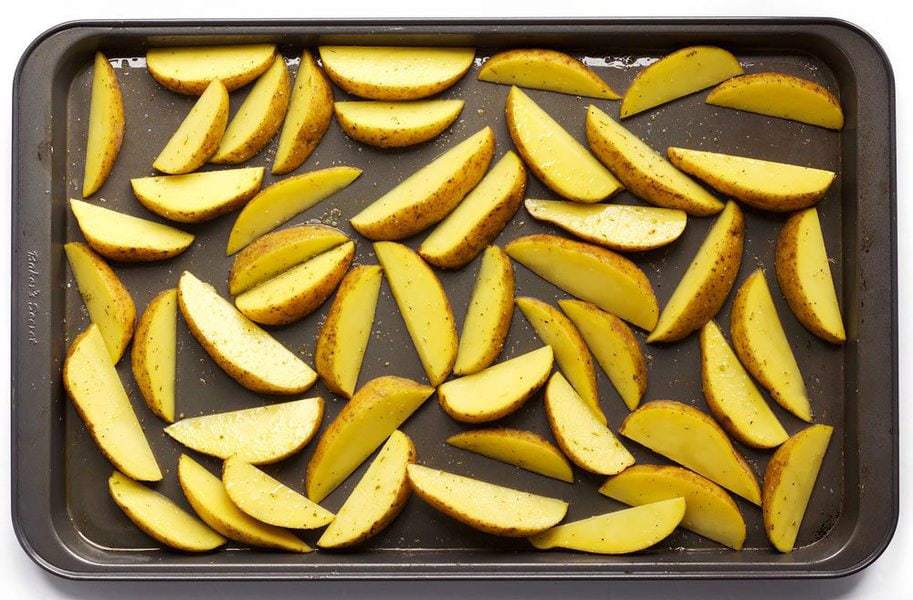 Seasoned Potato Wedges on the baking sheet