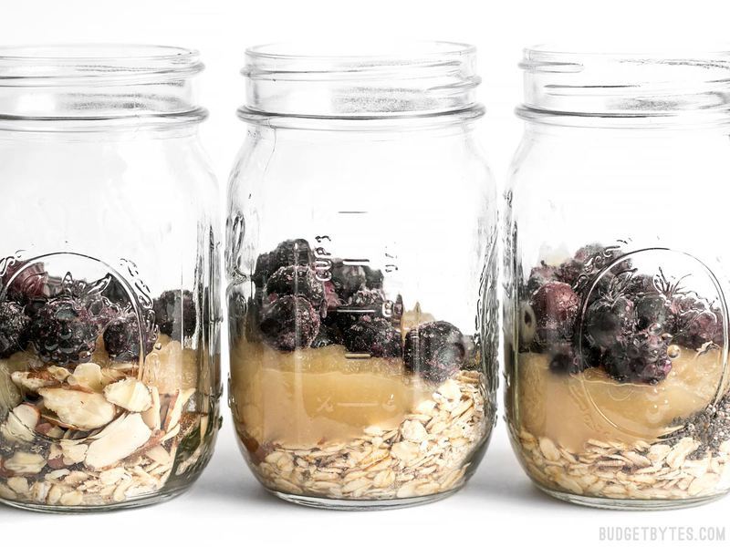 Three mason jars with Blueberry Almond Overnight Oats in a row