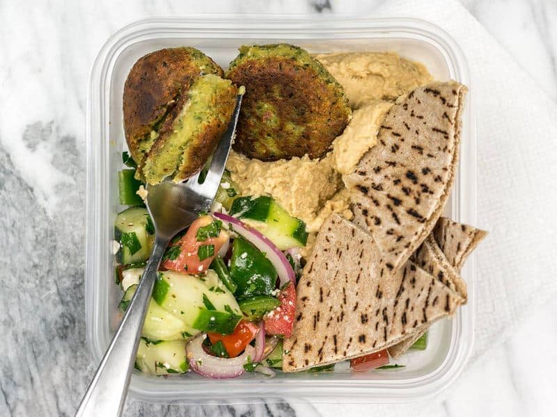 One Falafel and Hummus Box Meal Prep being eaten with a fork