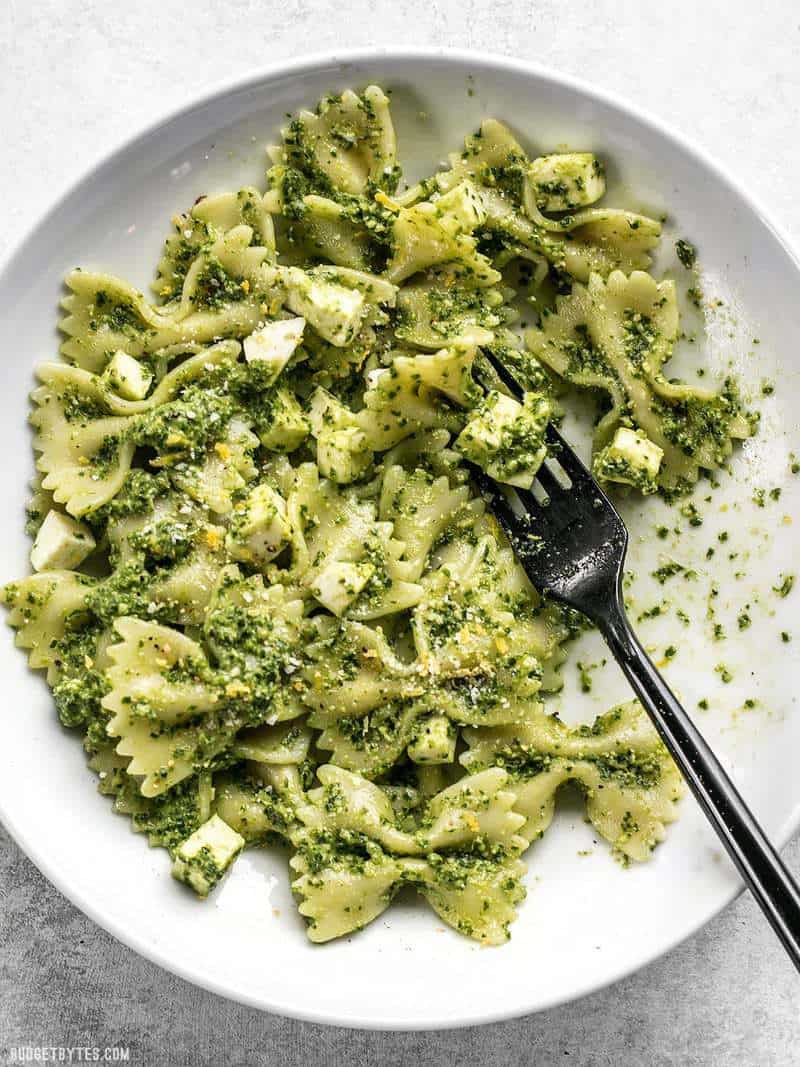 Kale Pesto pasta in a white bowl with a black fork
