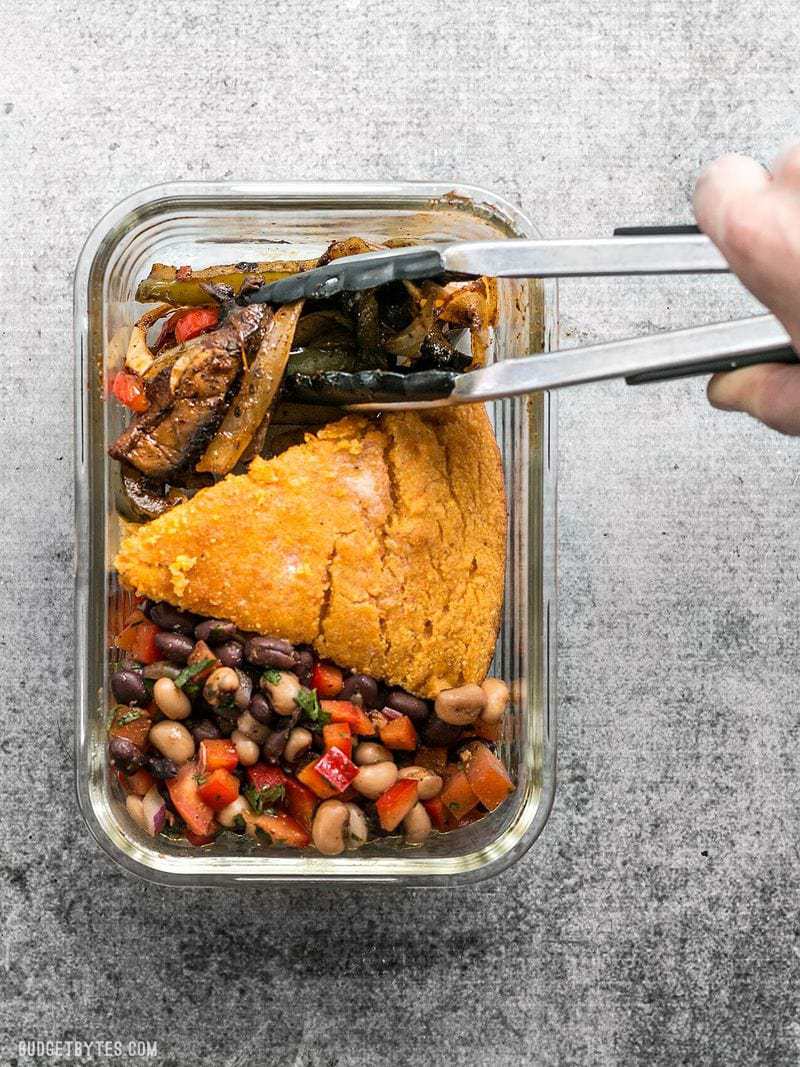 chipotle portobello fajita mixture being added to the meal prep container