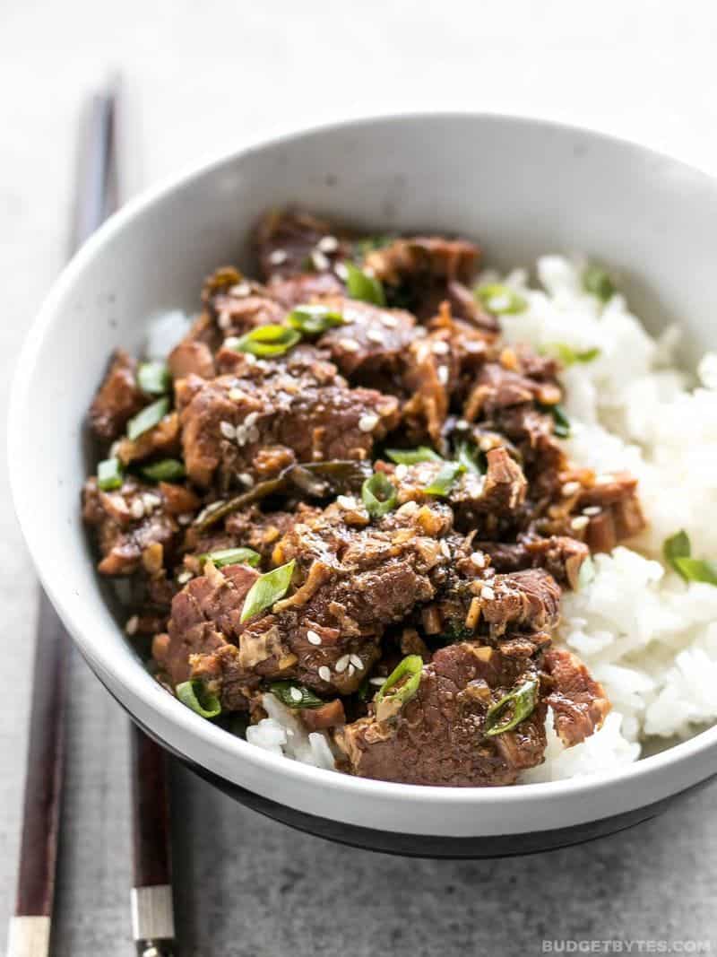 Front view of a bowl full of Slow Cooker Sesame Beef and rice