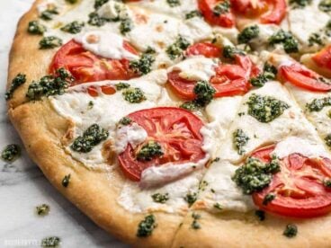 Take your Marghertia pizza up a level with a drizzle of zesty parsley pesto. This white pizza is anything but boring. BudgetBytes.com