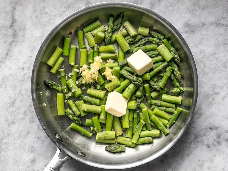 Add Butter and Garlic to skillet with asparagus