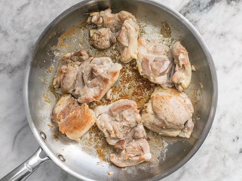 Brown Chicken Thighs in skillet