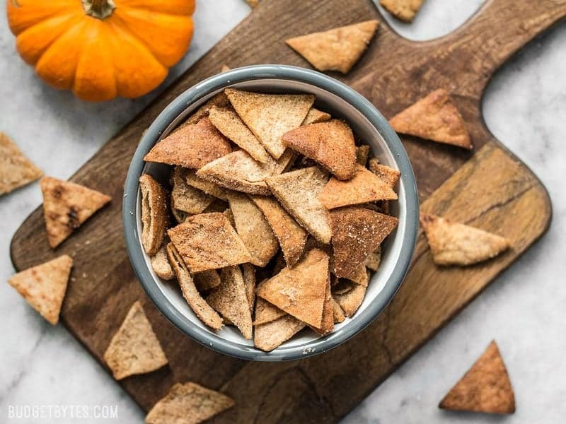 Finished Cinnamon Pita Crisps in a bowl next to a pumpkin