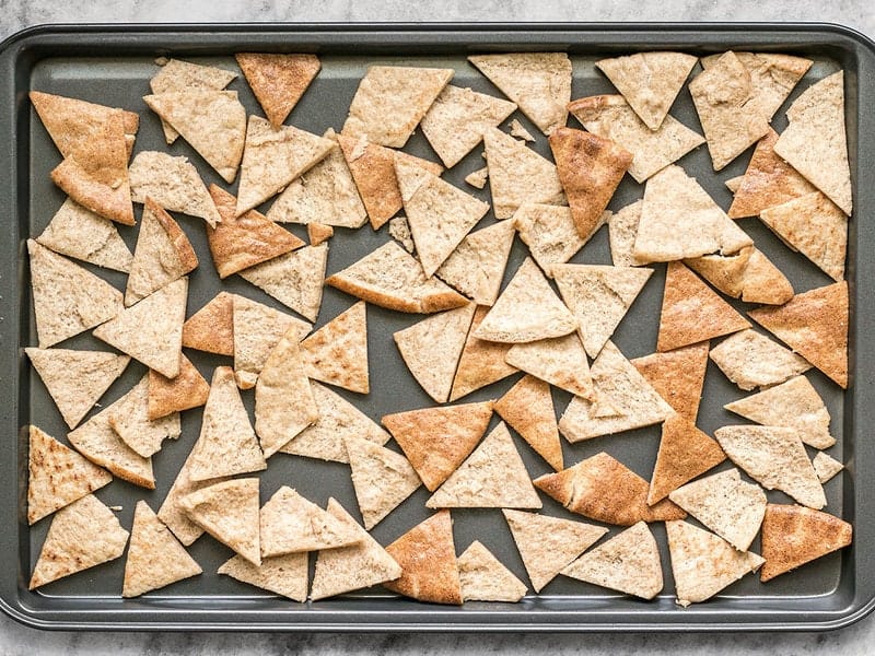 Spread pita triangles on a baking sheet