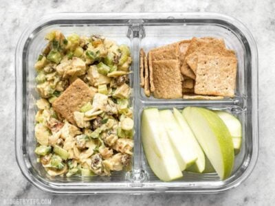 Curry Chicken Salad is paired with crunchy crackers for dipping and a tart apple to cleanse the palate in this simple cold lunch box. BudgetBytes.com