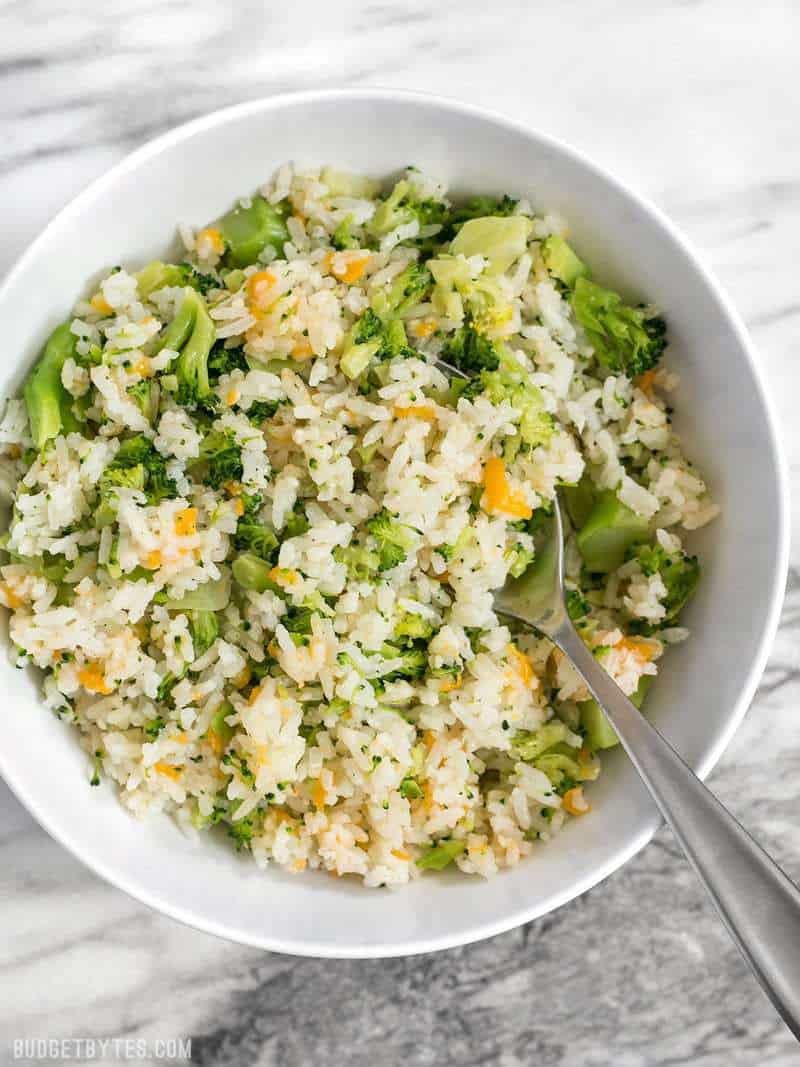 A big bowl of Easy Cheesy Broccoli Rice on a marble countertop 