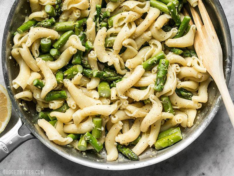 Close up of the skillet full of Lemon Garlic Asparagus Pasta with a wooden fork