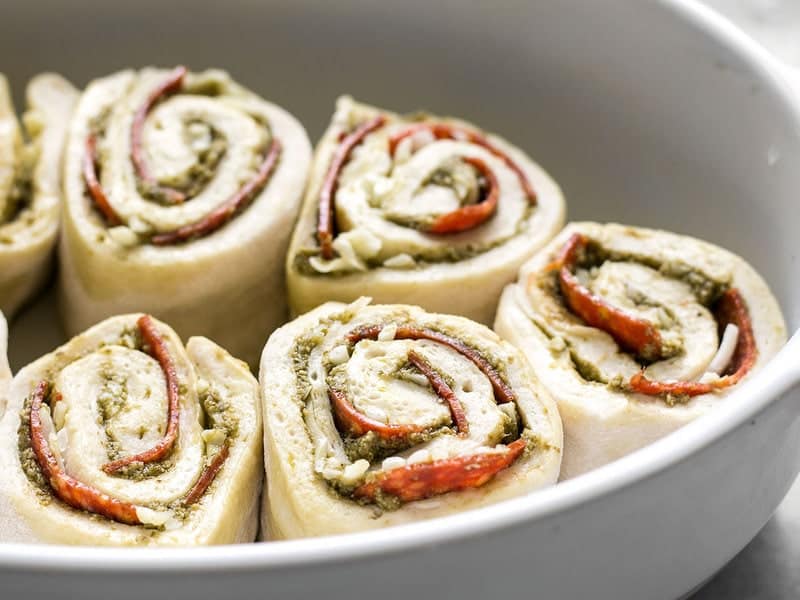 Unbaked Pesto Pizza Rolls in Dish