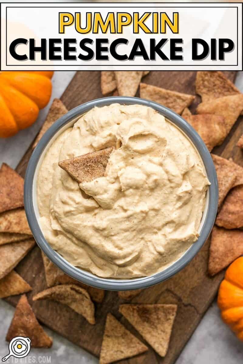 Overhead view of a bowl full of pumpkin cheesecake dip surrounded by cinnamon pita crisps.