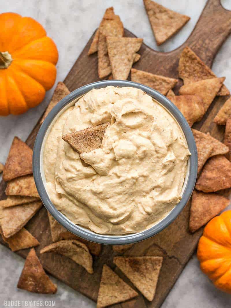 A full bowl of fluffy Pumpkin Cheesecake Dip with Cinnamon Pita Crisps for dipping.