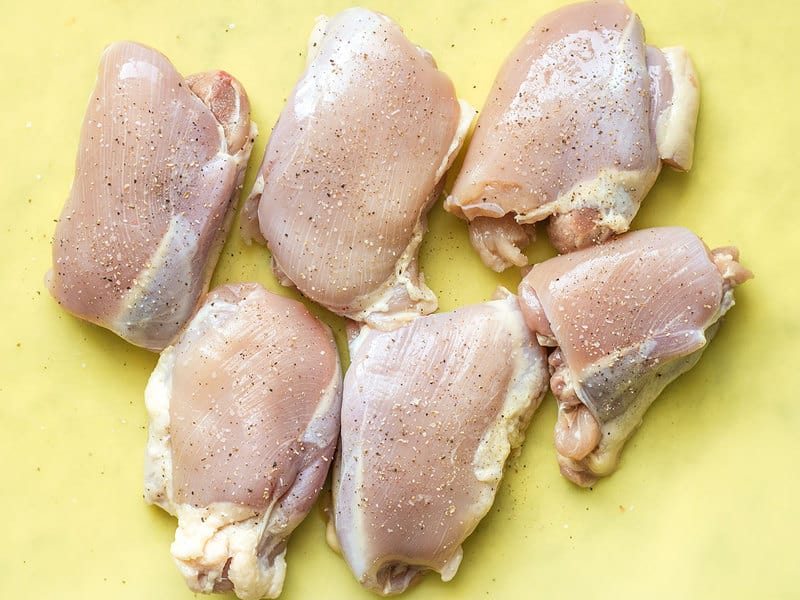 Raw Chicken Thighs with salt and pepper