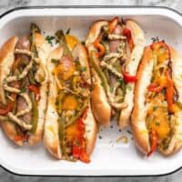 You don't need a grill to make these sweet and tangy Roasted Bratwurst with Peppers and Onions because the oven does all the work. BudgetBytes.com