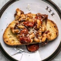 For a quick, flavorful, and light lunch, this Garlic Toast with Blistered Tomatoes and White Beans hits the spot! BudgetBytes.com