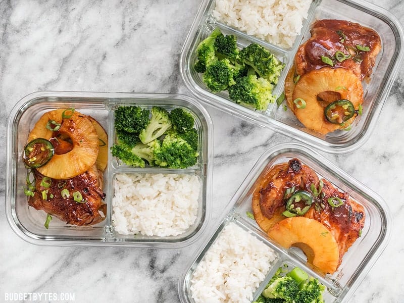 Three Pineapple BBQ Chicken Meal Prep containers scattered