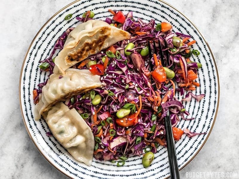 A plate of Sesame Slaw with gyoza