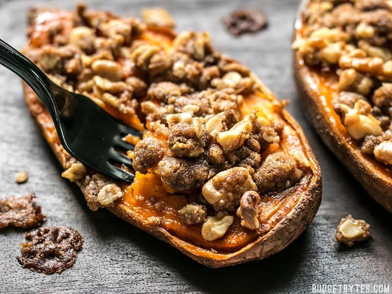 Streuseled Sweet Potatoes are an easy, deconstructed version of the classic sweet potato casserole that is manageable enough for weeknight dessert. BudgetBytes.com Close up of a fork digging into a Streuseled Sweet Potato