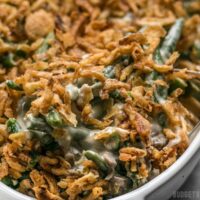 close up of green bean casserole being scooped out of the dish