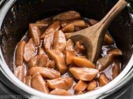 Slow Cooker Hot Buttered Apples are an easy and versatile dessert that is perfect for using up your glut of autumn apples! BudgetBytes.com