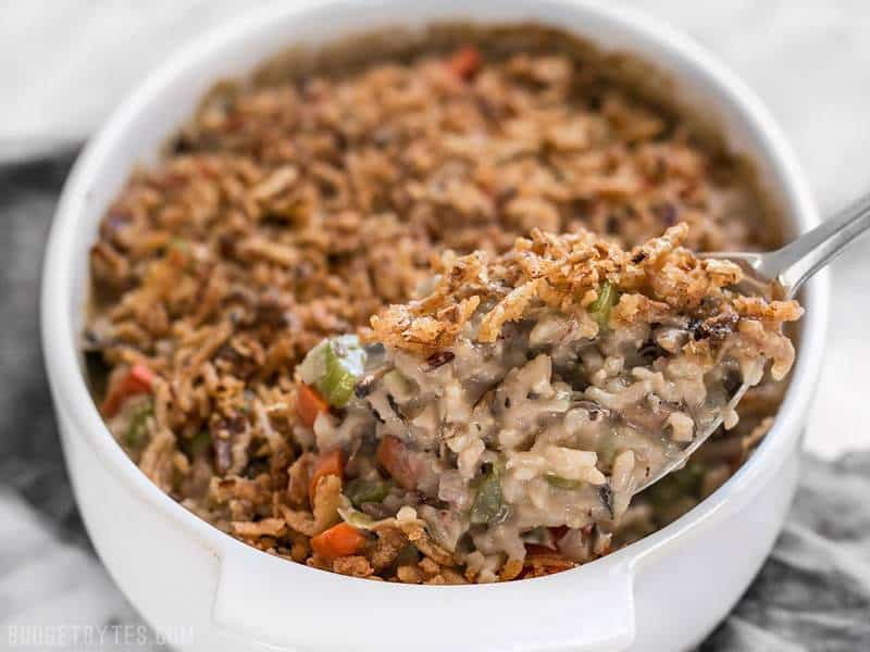 Plenty of vegetables, a hearty wild rice blend, and a super creamy sauce make this Wild Rice and Vegetable Casserole a warm comforting dish for winter! BudgetBytes.com Close up of a scoopful of Wild Rice and Vegetable Casserole