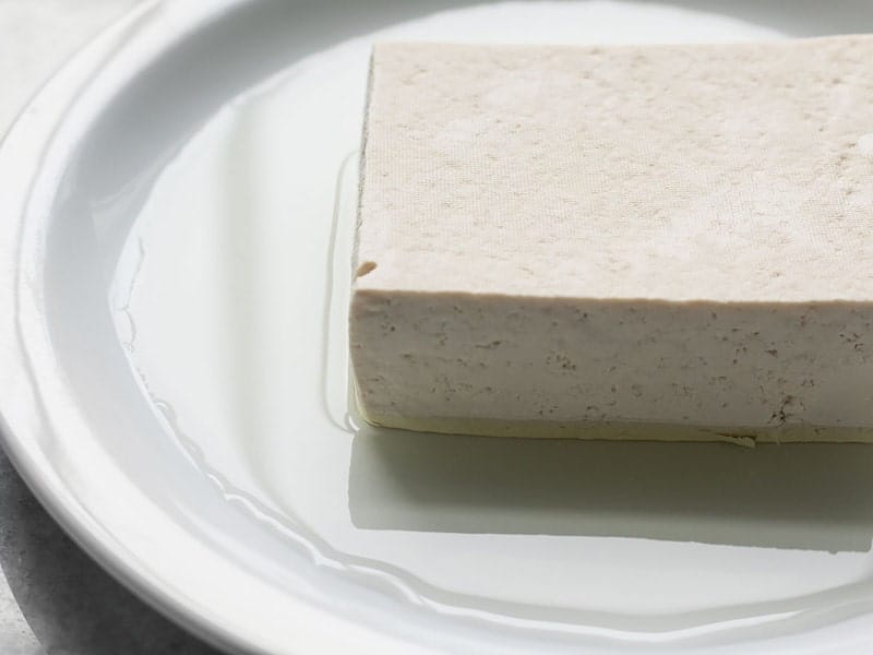 Liquid seeping from block of tofu