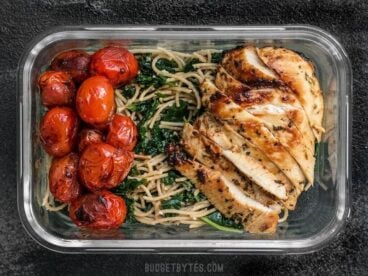 This Garlic Parmesan Kale Pasta Meal Prep includes Garlic Marinated Chicken and brightly flavored blistered tomatoes for a well rounded and delicious meal! BudgetBytes.com