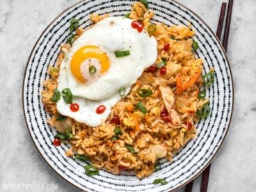 This Kimchi Fried rice is tangy, spicy, and the perfect way to use up all the leftover ingredients and scraps in your kitchen. BudgetBytes.com