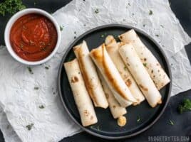 Forget frozen pizza rolls! These Pizza Roll Ups are the perfect last minute appetizer or indulgent snack on busy days! BudgetBytes.com