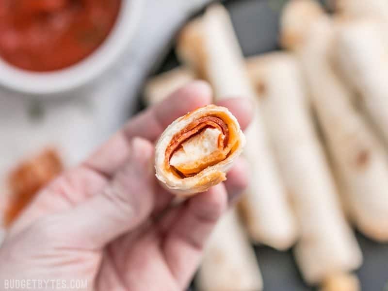 Close up of the inside of a Pizza Roll Up being held in a hand