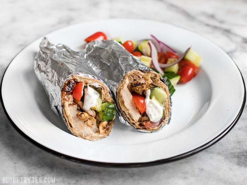Finished Greek Chicken Wraps on a plate with salad