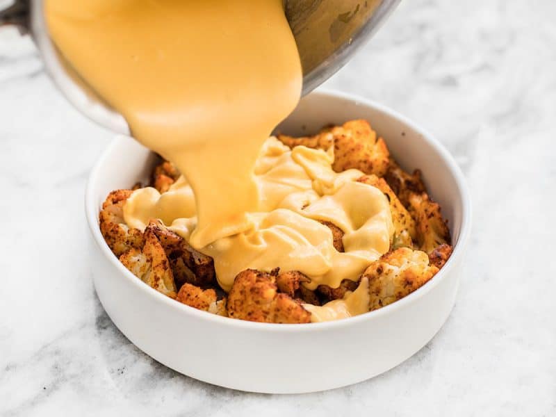 Pour Cheese Sauce Over Spicy Roasted Cauliflower