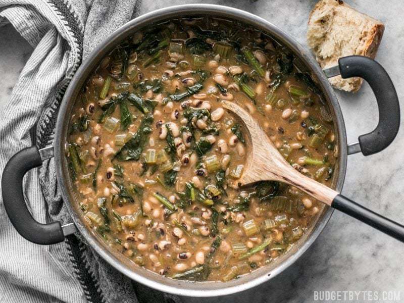 Slow Simmered Black Eyed Peas and Greens is a great cold weather comfort food that is as healthy as it is delicious! BudgetBytes.com