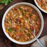 Overhead view of 15 bean soup in a bowl with a spoon.
