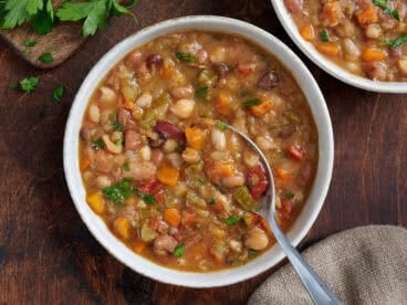 Overhead view of 15 bean soup in a bowl with a spoon.