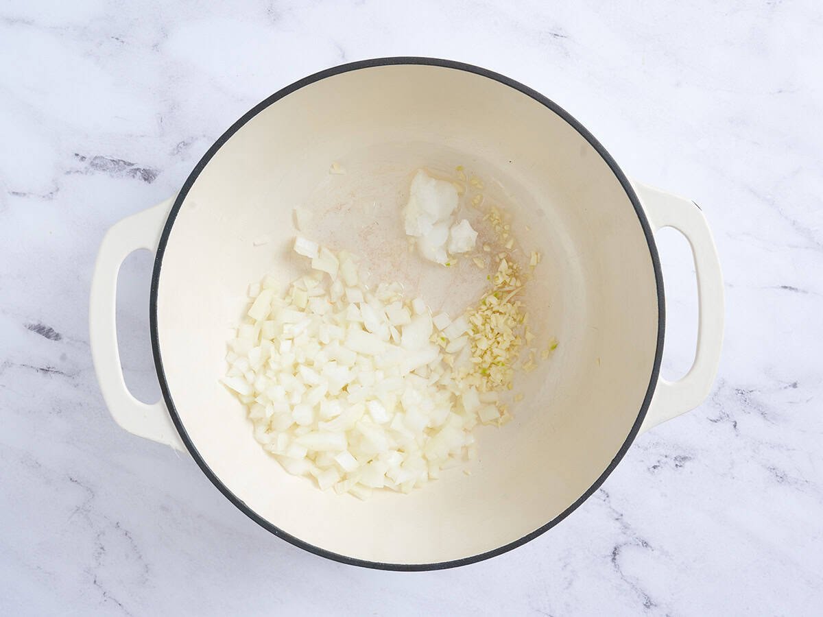 Onion and garlic sautéing in a pan.