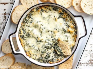 Double Spinach Artichoke Dip is PACKED with spinach, three types of cheese, and just enough spice to tingle your taste buds. BudgetBytes.com