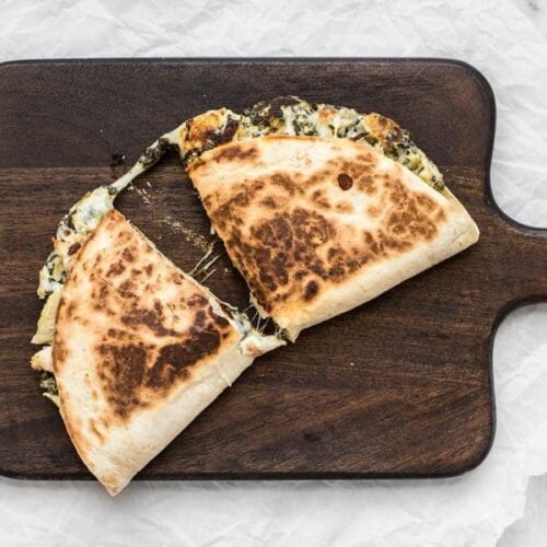 Use your leftover party dips to make a delicious lunch the next day, like these super creamy Spinach Artichoke Quesadillas. BudgetBytes.com