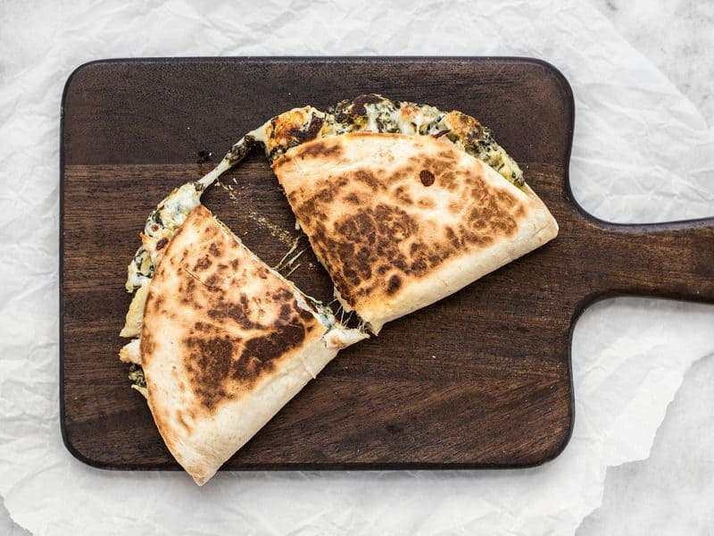 Use your leftover party dips to make a delicious lunch the next day, like these super creamy Spinach Artichoke Quesadillas. BudgetBytes.com