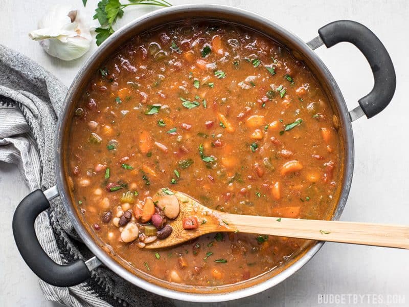 A variety of colors, fresh vegetables, and vibrant herbs and spices make this Vegetarian 15 Bean Soup flavorful, filling, AND incredibly good for you. BudgetBytes.com