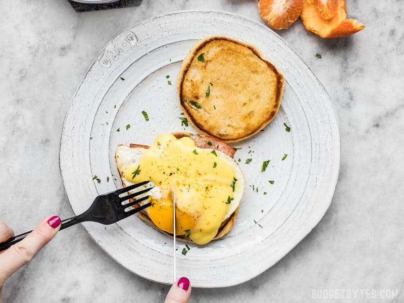 A serving of Almost Eggs Benedict being eaten with a knife and a fork. 