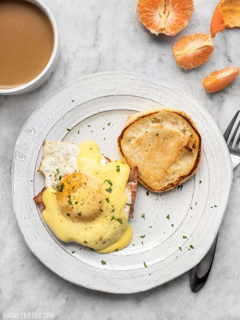 One serving of Almost Eggs Benedict with a cup of coffee next to it