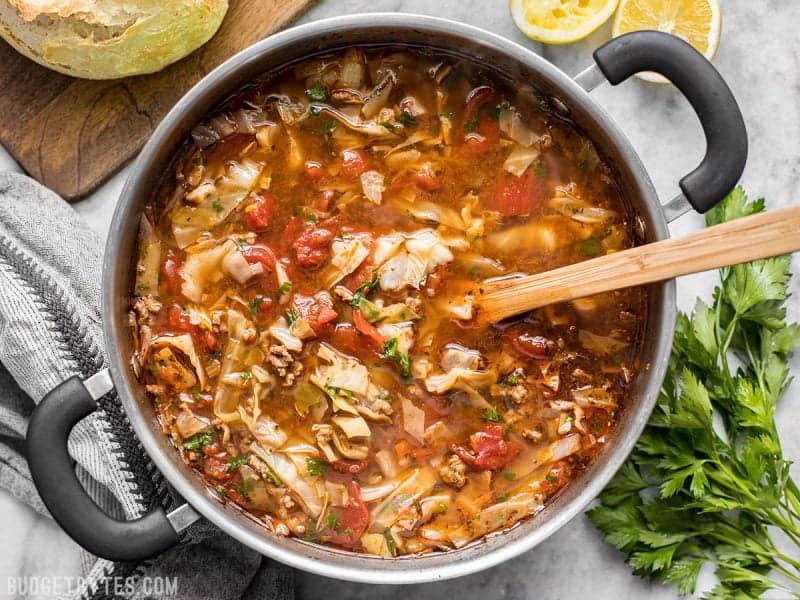 Finished Beef and Cabbage Soup with a wooden spoon