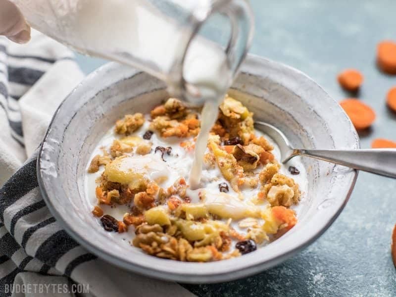 Milk being poured onto a bowl of Carrot Cake Baked Oatmeal 
