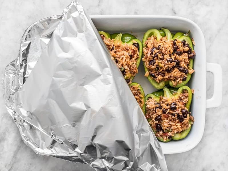 Stuffed Bell Peppers in casserole dish covered with foil
